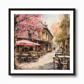 watercolor painting of a cafe with tables and chairs outside of it and a tree with pink flowers on it Art Print