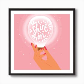 Shine On Hand Lettering With Hand Holding A Light Bulb On Pink Square Art Print