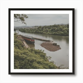 A Train Passes In Front Of The River With Green Trees Art Print