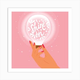 Shine On Hand Lettering With Hand Holding A Light Bulb On Pink Square Art Print