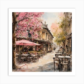 watercolor painting of a cafe with tables and chairs outside of it and a tree with pink flowers on it Art Print