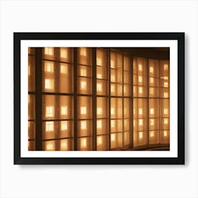 A Building With A Large, Curved Window That Is Illuminated With Warm, Yellow Light Art Print