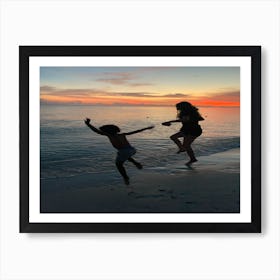 Jumping into the beach sunset Art Print