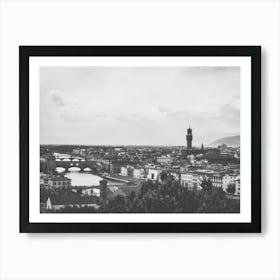 Panoramic View of Florence. This image depicts a panoramic view of Florence, Italy, showcasing its iconic architectural landmarks. The prominent structures include the Florence Cathedral with its distinctive dome and the Palazzo Vecchio with its tall tower. The cityscape is set against a backdrop of rolling hills and a partly cloudy sky, capturing the historical and cultural essence of Florence. Art Print