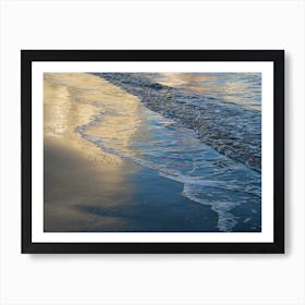 Reflections on the sandy beach at sunset Art Print