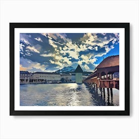 Lucerne, Scenic View of a Historic Bridge and Tower by the Water. This image depicts a picturesque scene featuring a historic wooden bridge extending over a calm body of water, leading to a distinctive tower. The background showcases a dramatic sky filled with dynamic clouds and a mountain range, adding depth and grandeur to the scene. The buildings along the waterfront and the reflections in the water enhance the overall aesthetic appeal, making it a visually captivating and serene landscape. Art Print