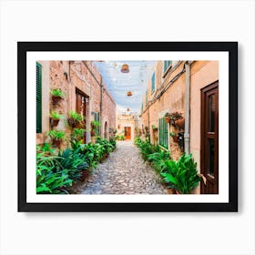 Old village Valldemossa on Mallorca, Spain Balearic islands. This romantic street is a famous landmark that depicts the rich history and Mediterranean culture of the town. The narrow alley is brimming with charming potted plants and flowers, adding to the allure of the picturesque village. Art Print