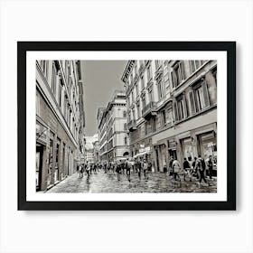 Bustling Streets of Florence. A monochromatic view of a lively street in Florence, Italy, where people stroll past historic buildings and shops. The scene captures the timeless charm and energy of Florence’s architecture and city life. Art Print