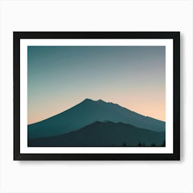 Photo Of A Mountain Range Silhouetted Against A Blue And Orange Sky Art Print