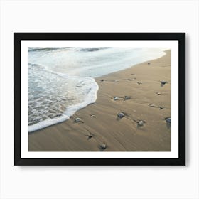 Gentle waves meet the sandy beach Art Print