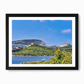 Capo Caccia Sardinia. This image shows a green, mountainous landscape bordering calm blue water, with a sailboat in the foreground. The background includes rugged peaks and scattered historical structures, all beneath a bright, clear sky. Art Print