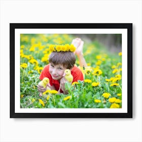 The boy lies in the grass with funny ducklings. Art Print