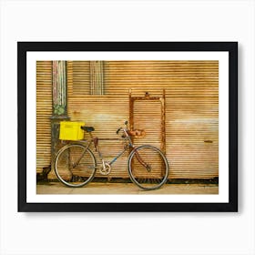 Bicycle Leaning Against Rusty Shutters Art Print