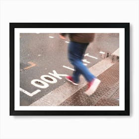 London, England I Pedestrian in motion on a crossing with Look Left inscription on the ground under the rain in the urban dynamic of a London street photography with a retro vintage autumn aesthetic Art Print