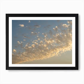 Soft clouds and warm sunlight at sunset Art Print