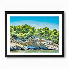 Rocky Shoreline with Lush Trees. The image depicts a scenic view of a rocky shoreline bordered by a lush forest. The rocks are rugged and varied in color, ranging from light beige to dark gray, and are bathed in sunlight. Above the rocks, a dense collection of trees with vibrant green foliage stretches across the horizon, contrasting beautifully with the clear blue sky. The water in the foreground is calm, reflecting the colors of the rocks and trees. Art Print