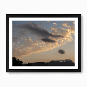 Cloudy sky and mountain silhouette at sunset Art Print