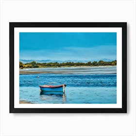 Serene Blue Boat. This image shows a small, colorful boat floating calmly on a serene body of water, with a backdrop of distant mountains and a blue sky. The setting is tranquil, with gentle ripples on the water and a shoreline lined with trees. Art Print