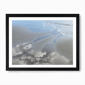 Sand, sea water and reflection of clouds Art Print