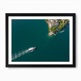 The boat sails to the island on the lake in Italy. Drone photography Art Print