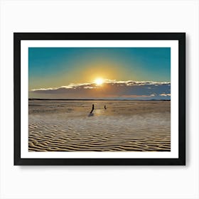 Sunset Beach in Riviera. The image depicts a serene sunset over a sandy beach. The sun, a bright orb of golden light, is partially obscured by a single cloud, casting a warm glow across the scene. The sky transitions from a vibrant blue to a soft orange and pink, creating a beautiful gradient. In the foreground, the beach is covered in intricate patterns of sand ripples, formed by the receding tide. Art Print