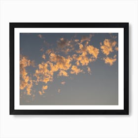 Scenic sunset clouds in pale blue sky Art Print