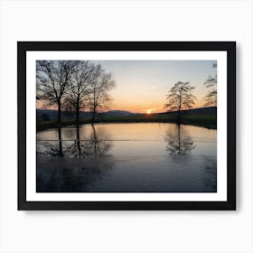 Winter reflection of trees in a pond at sunset Art Print