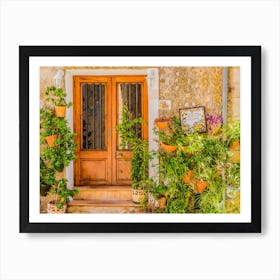 Traditional flower pots decorate the walls of the narrow streets and residential buildings, bringing color and beauty to the village's charming architecture. These potted plants are not only a nod to the island's Mediterranean culture, but also a symbol of the village's rich history and tradition. Art Print