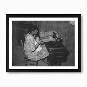 Wife Of Sharecropper, With Baby In Her Lap, At Sewing Machine, Family Will Work Under Tenant Purchase Program Art Print