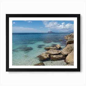 Clear, blue sea water and rocks on the beach Art Print