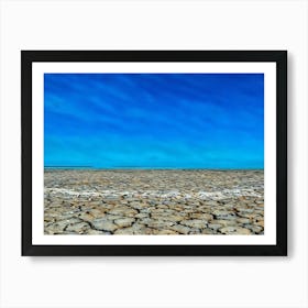 Cracked Earth Texture in Camargue. The image showcases a close-up view of cracked earth, revealing a network of intricate fissures and crevices. The dominant color is a muted gray, with subtle variations in shade and texture. The cracks are deep and pronounced, creating a sense of dryness and aridity. The overall mood is one of desolation and harshness, highlighting the effects of drought or lack of moisture. 2 Art Print