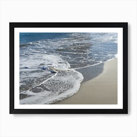 Blue sea water meets sand on the beach Art Print