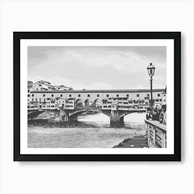 Ponte Vecchio Over the Arno River. A black-and-white depiction of Florence’s iconic Ponte Vecchio bridge, stretching over the Arno River. This historic bridge, adorned with small shops and classic Italian architecture, embodies the timeless beauty of Florence. Art Print