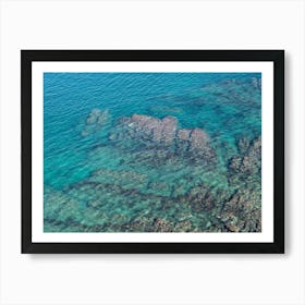 Aerial view of rocks and blue sea water Art Print