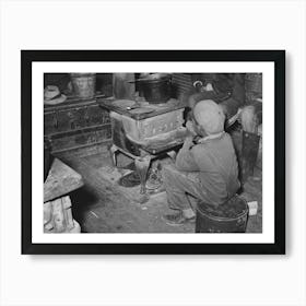 Boy Sitting By The Stove On A Cold Day In The Strawberry Picking Season, Near Independence, Louisiana By Russell Lee Art Print