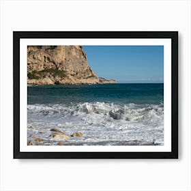 Foaming sea water and cliffs on the beach Art Print