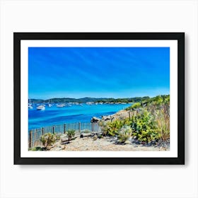 Serene Seascape Escape. The image depicts a tranquil coastal scene featuring a small, lush island surrounded by clear blue waters. Several boats are anchored nearby, and a person is seen riding a jet ski, leaving a trail of white foam behind. The sky is clear, enhancing the vibrant blue hues of the sea and sky, creating a picturesque and serene atmosphere. 3 Art Print