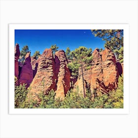 Ochres Land Majestic Cliffside Forest. This image showcases a stunning cliffside landscape adorned with lush green trees. The rocky formations exhibit a range of warm hues, from sandy yellows to deep reds, creating a striking contrast against the vibrant blue sky. The scene captures the beauty of nature's rugged terrain and the resilience of trees growing on steep, rocky surfaces. 6 Art Print