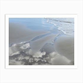 Sand, sea water and reflection of clouds Art Print