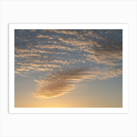 Golden-yellow clouds in the sky at sunrise Art Print