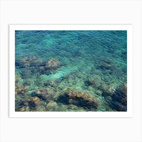 Clear blue sea water in a rocky cove Art Print