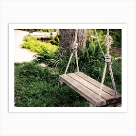 Old Wooden Vintage Swing Hanging From A Large Tree In The Garden With Green Grass Background Art Print