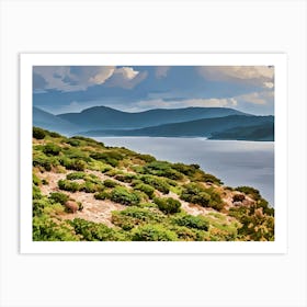 Green coastal landscape in Sardinia. This image showcases a lush, green coastal landscape with low bushes and rocky terrain in the foreground, leading to a calm, reflective sea. Behind the water, gentle hills rise, creating layers of soft blue and green hues under a partly cloudy sky. The scene is peaceful and captures the natural beauty of Sardinia’s coastal environment. Art Print