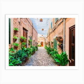 Old village Valldemossa on Mallorca, Spain Balearic islands. This romantic street is a famous landmark that depicts the rich history and Mediterranean culture of the town. The narrow alley is brimming with charming potted plants and flowers, adding to the allure of the picturesque village. Art Print