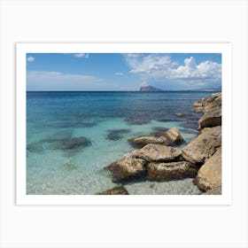 Clear, blue sea water and rocks on the beach Art Print