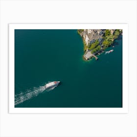 The boat sails to the island on the lake in Italy. Drone photography Art Print