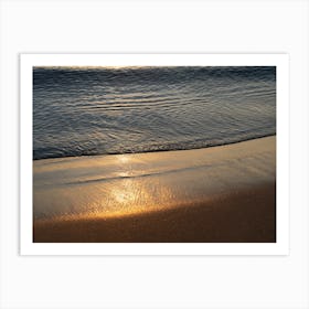 Sunrise and golden reflections at the beach Art Print