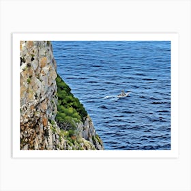 Boat on the Sea near Capo Caccia Sardinia. This image shows a view from the top of a steep, winding staircase descending between two rugged limestone cliffs toward the blue Mediterranean Sea. A small boat cruises along the calm waters in the distance, adding a sense of scale to the vastness of the sea. This scene captures the dramatic coastal landscape of Capo Caccia in Sardinia, Italy. 1 Art Print