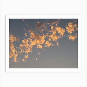 Scenic sunset clouds in pale blue sky Art Print