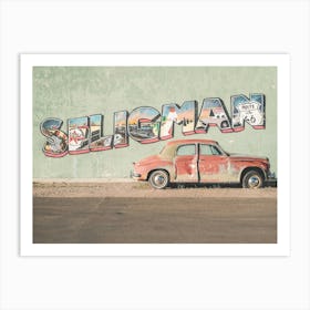 Route 66, USA I Vintage American car in front of a street art typography photography wall in Seligman in Arizona in the retro vintage american countryside during travel road trip on historic Route 66 in California Art Print